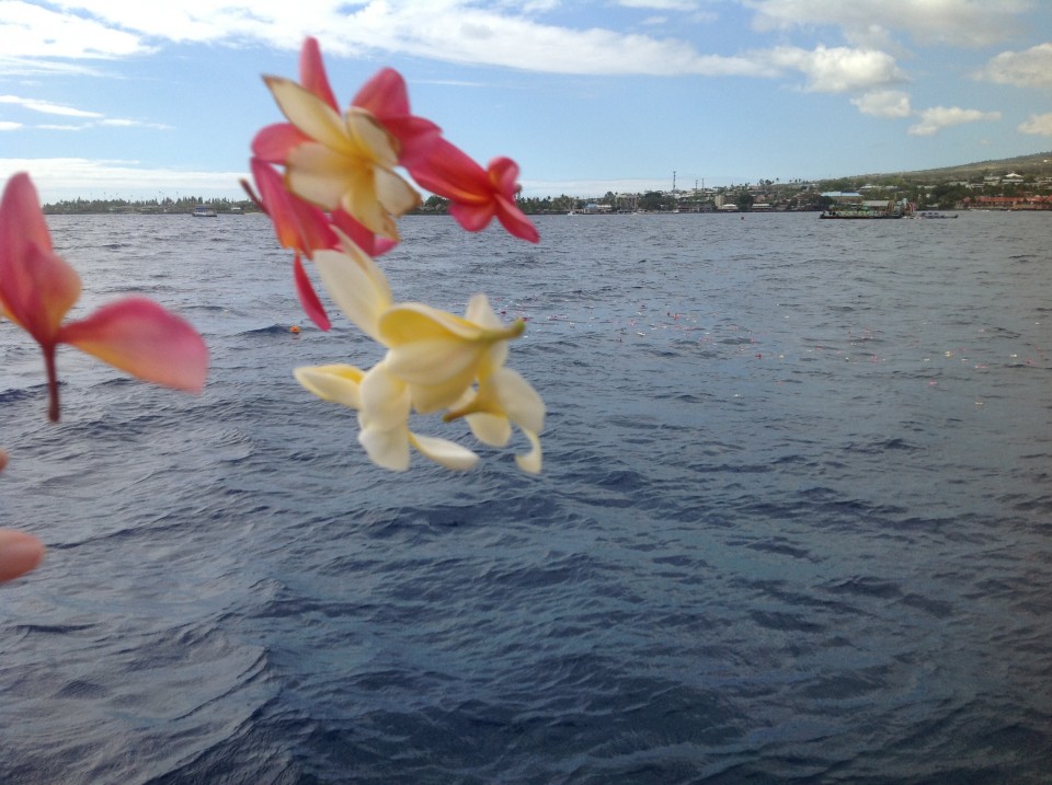 Throwing flowers into ocean